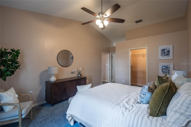 carpeted bedroom featuring a closet, a spacious closet, vaulted ceiling, and ceiling fan