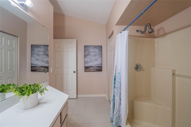 bathroom with tile patterned flooring, a shower with curtain, a textured ceiling, and vanity