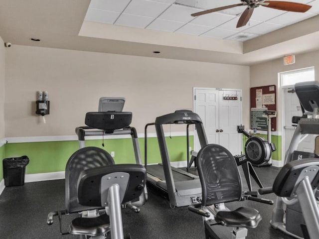 workout area featuring a paneled ceiling and ceiling fan