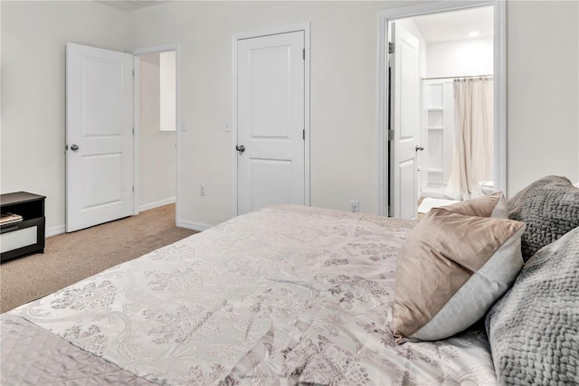 carpeted bedroom featuring ensuite bathroom