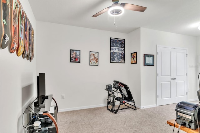 workout area with ceiling fan and light colored carpet