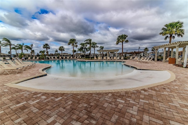 view of swimming pool with a patio area and a pergola