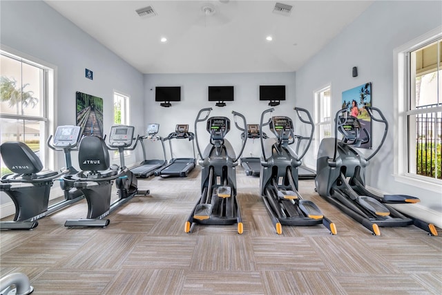 gym with plenty of natural light and light colored carpet