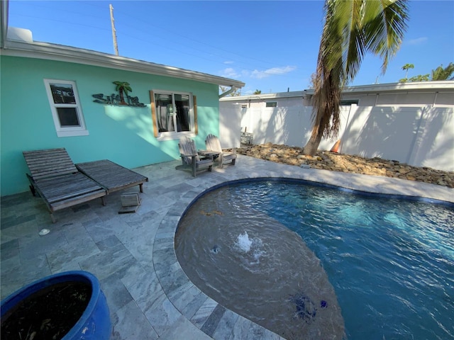 view of swimming pool featuring a patio area