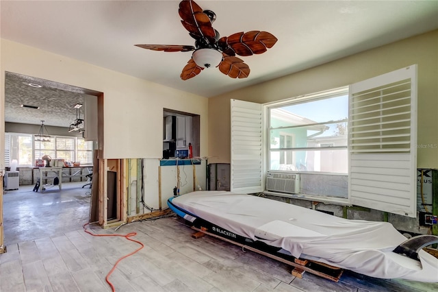 bedroom featuring hardwood / wood-style floors, ceiling fan, and cooling unit