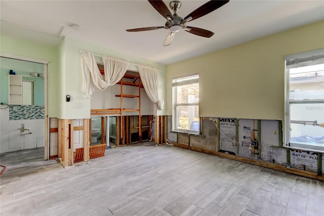 miscellaneous room featuring ceiling fan and light hardwood / wood-style flooring