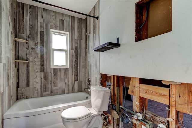 bathroom featuring wooden walls, shower / tub combination, and toilet