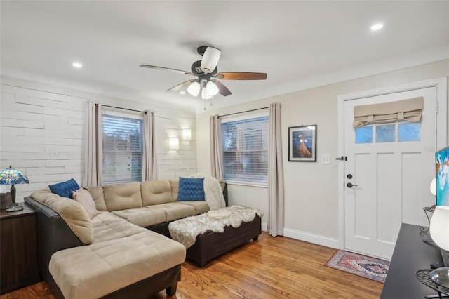 living room featuring ceiling fan and light hardwood / wood-style floors