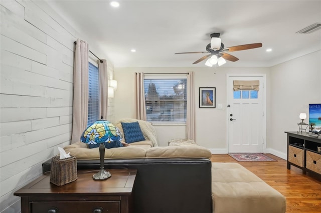 living room featuring ceiling fan and hardwood / wood-style flooring