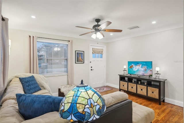 living room featuring ceiling fan and wood-type flooring