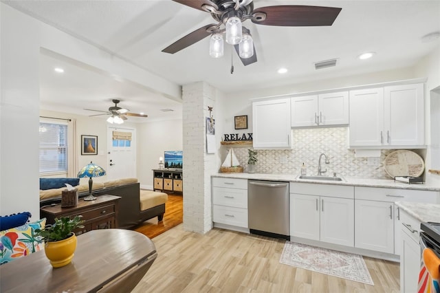 kitchen with light wood-type flooring, white cabinetry, sink, and appliances with stainless steel finishes