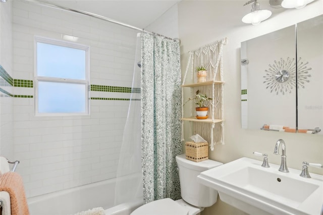 full bathroom with toilet, sink, and shower / tub combo with curtain