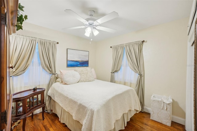 bedroom with ceiling fan and dark hardwood / wood-style flooring