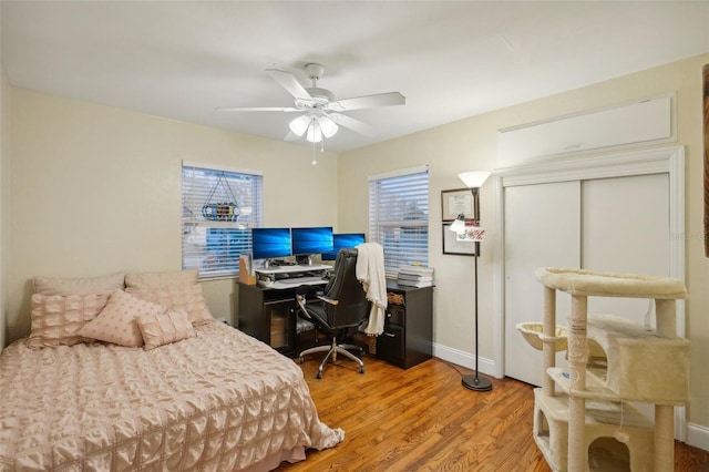 bedroom with wood-type flooring and ceiling fan