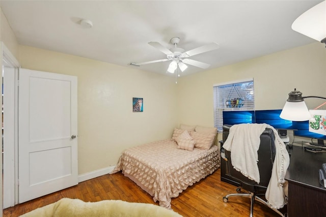 bedroom with ceiling fan and dark wood-type flooring