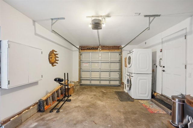 garage with a garage door opener and stacked washer and clothes dryer