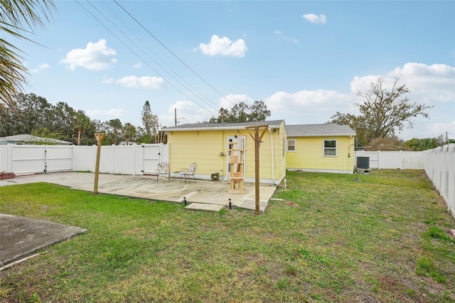 back of house with a patio, central AC unit, and a lawn