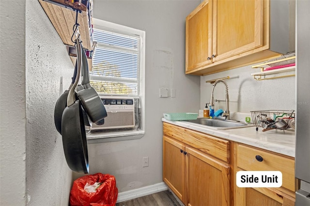 clothes washing area with sink and hardwood / wood-style flooring