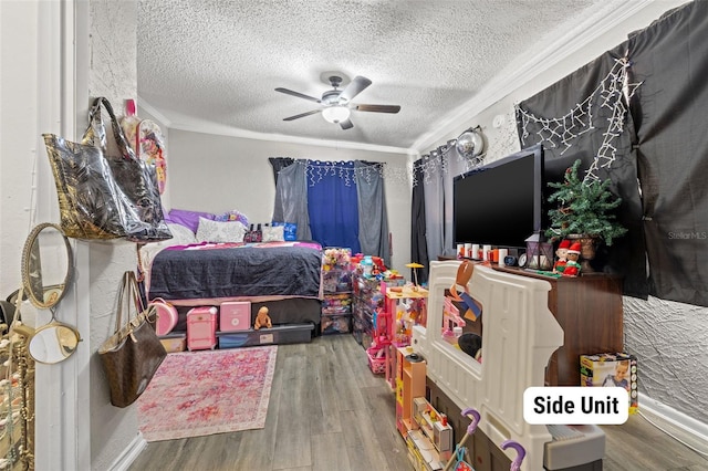 bedroom featuring ceiling fan, crown molding, a textured ceiling, and hardwood / wood-style flooring