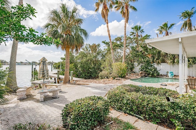 view of yard featuring a patio area and a water view