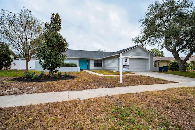 ranch-style home featuring a front yard and a garage