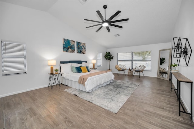 bedroom with light hardwood / wood-style floors, high vaulted ceiling, and ceiling fan