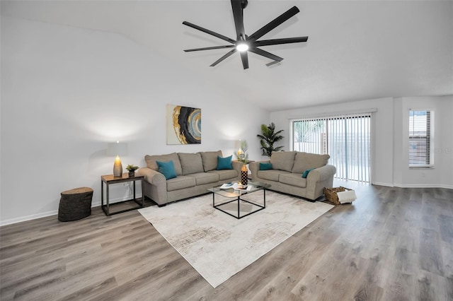 living room with hardwood / wood-style flooring, ceiling fan, and lofted ceiling