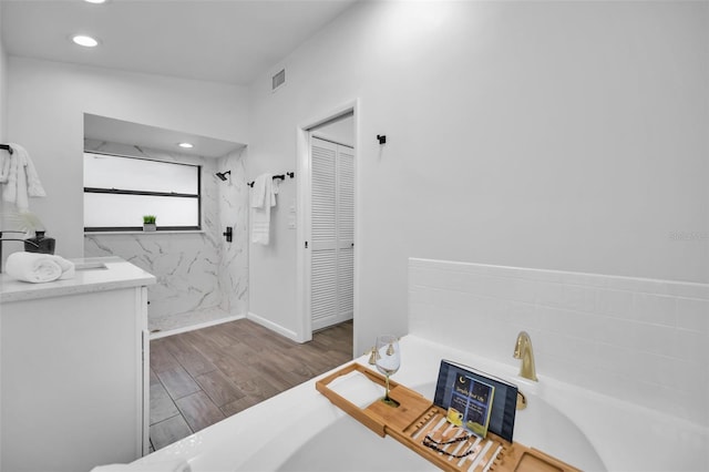 bathroom with vanity, wood-type flooring, and tile walls