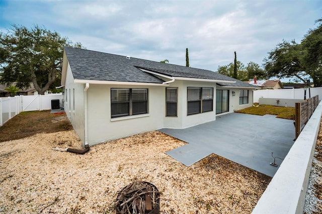 back of property featuring central AC and a patio