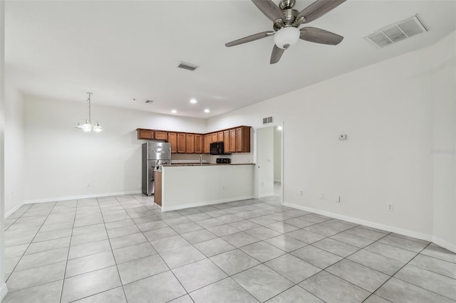 unfurnished living room featuring light tile patterned floors and ceiling fan with notable chandelier