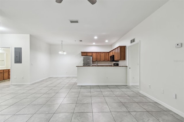 kitchen featuring hanging light fixtures, light tile patterned floors, ceiling fan with notable chandelier, and electric panel