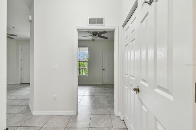 corridor with light tile patterned floors