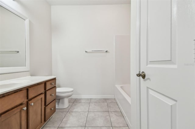 bathroom with a washtub, tile patterned floors, vanity, and toilet