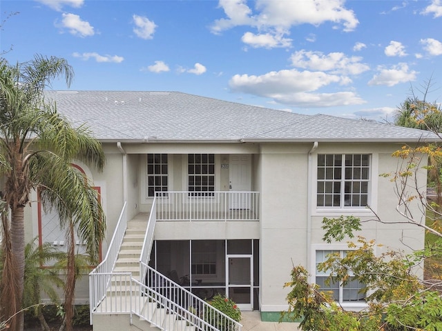 2632 River Preserve Ct, Bradenton, FL 34208 - back of property featuring stucco siding, a shingled roof, and stairway