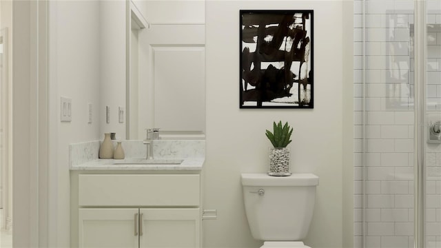 bathroom with vanity, toilet, and a shower with shower door