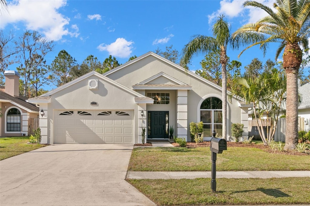 view of front of home featuring a garage and a front yard