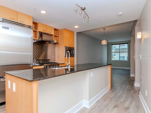 1120 E Kennedy Blvd Unit 927, Tampa, FL 33602 - kitchen featuring under cabinet range hood, built in appliances, open shelves, light wood-style floors, and tasteful backsplash