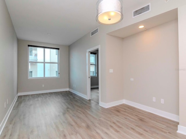 empty room with light hardwood / wood-style flooring