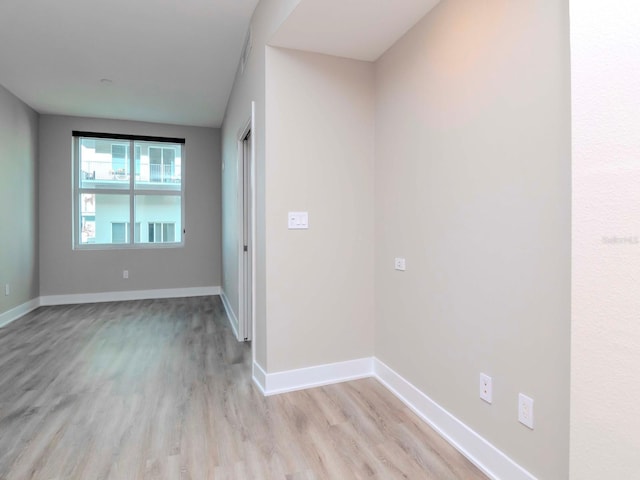 unfurnished room with light hardwood / wood-style flooring