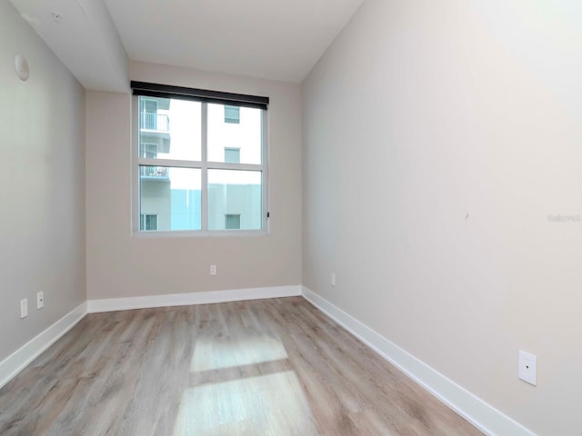 unfurnished room with light wood-type flooring