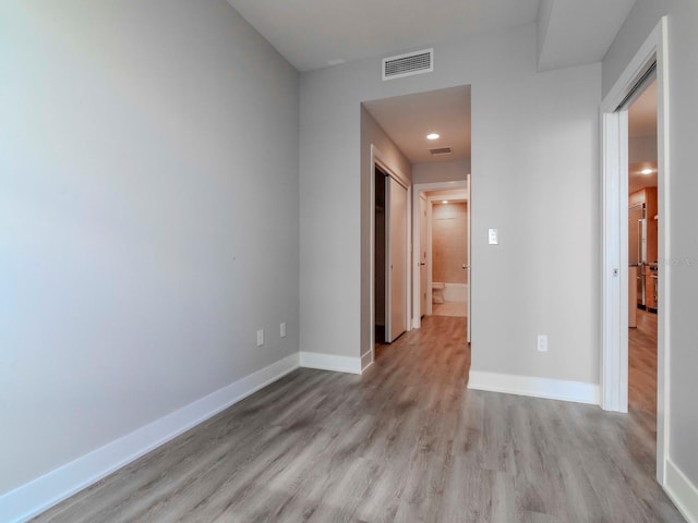 spare room with light hardwood / wood-style floors