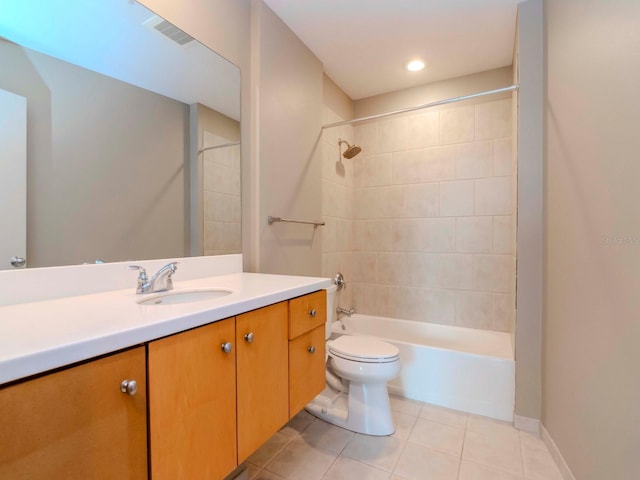 full bathroom featuring tile patterned flooring, vanity, tiled shower / bath combo, and toilet