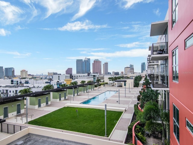 view of pool featuring a lawn and a patio