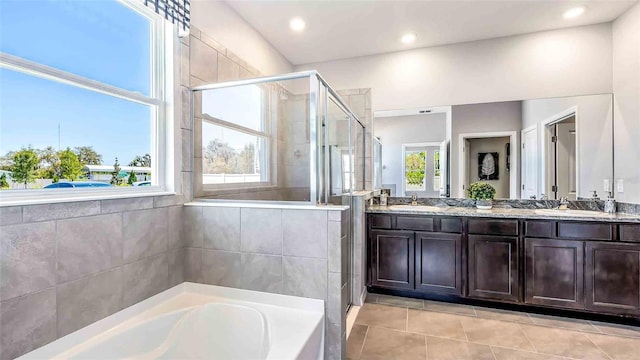 bathroom with plus walk in shower, vanity, and tile patterned floors