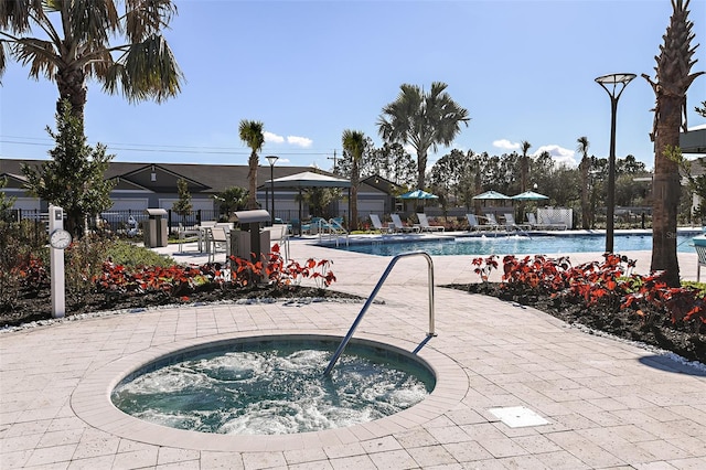 view of swimming pool featuring a community hot tub