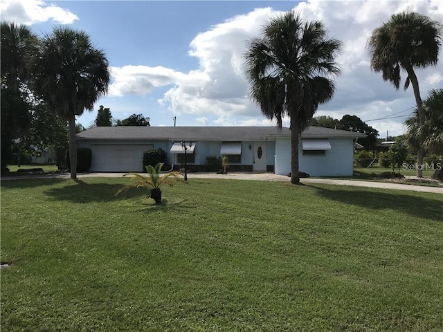 ranch-style house with a front yard and a garage