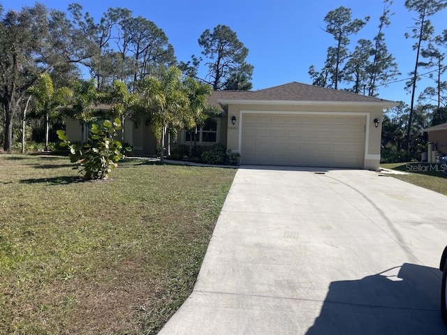 view of front of property featuring a garage and a front lawn