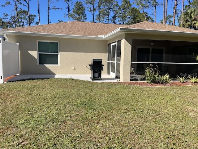 back of house featuring a lawn