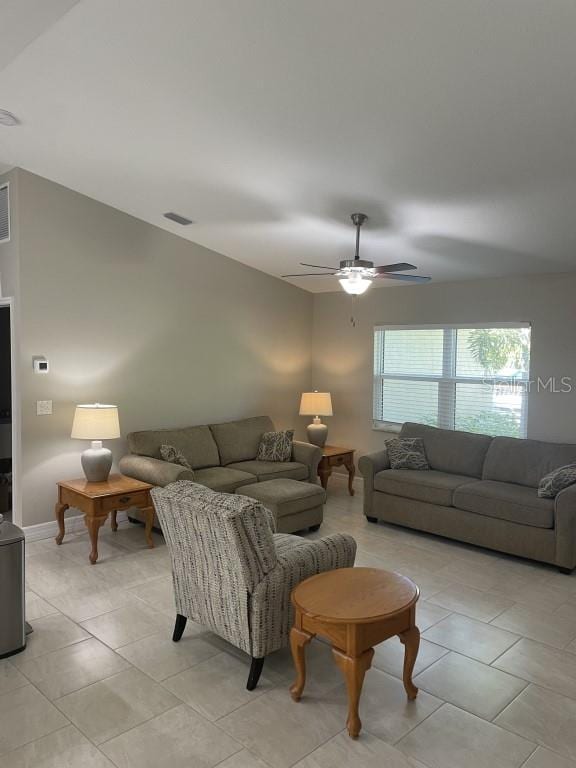 living room featuring light tile patterned floors and ceiling fan