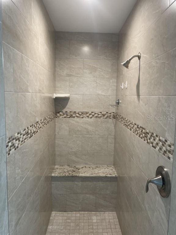 bathroom with a tile shower